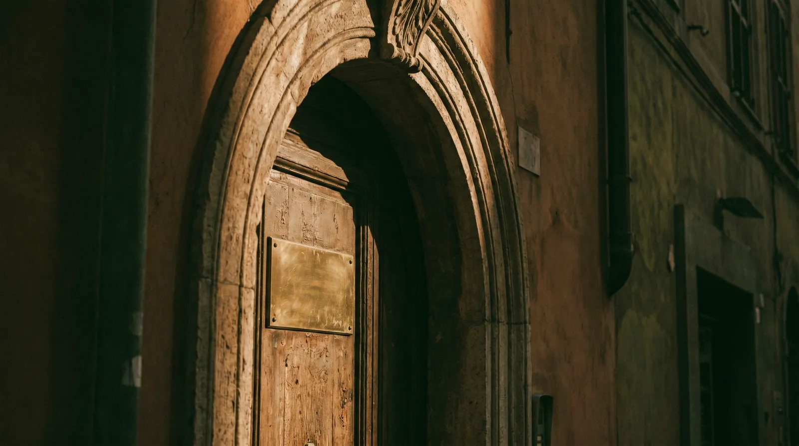 Elegant Roman doorway with a brass nameplate